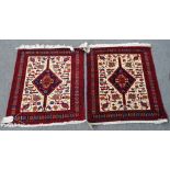 A pair of Baluchistan mats, the ivory field with indigo diamond, all with birds and flower motifs,