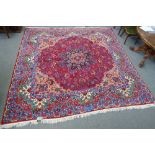 A Mashed carpet, Persian, inscribed, the burgundy carpet with a black faceted medallion,