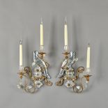 Attributed to Bagues, Paris, a pair of gilt metal and rock crystal two branch wall appliques,