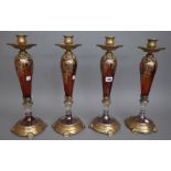 A set of four modern amber glass and gilt metal mounted candlesticks,