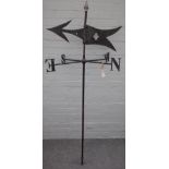 A black painted wrought iron weather vane, 20th century with flaming torch finial, 173cm high.
