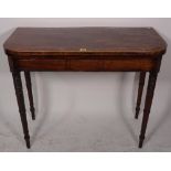 A Regency mahogany card table on ring turned tapering supports, 90cm wide x 74cm high.