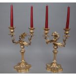 A pair of Rococo style gilt bronze twin branch candelabra, each raised on a shaped foot, 38cm high.