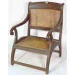 An unusual 19th century stained beech open armchair with cane back and seat, 62cm wide x 91cm high.