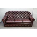 A 20th century tan leather button back sofa with downswept arms, 195cm wide x 88cm high.