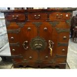 A 20th century Eastern metal bound side cabinet with three drawers over cupboards,