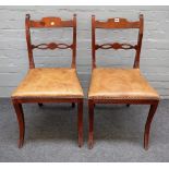 A pair of Continental early 19th century stained beech side chairs, on sabre supports,