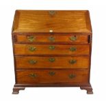 A George III mahogany bureau with four long graduated drawers on bracket feet,