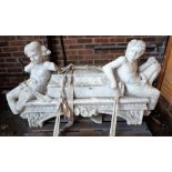 A marble chimney piece or fire surround with figural surmount and foliate relief carved supports,