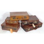 A group of five various leather suitcases, (5).