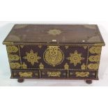 A 20th century African hardwood and brass studded trunk 90cm wide x 52cm high with three drawers.