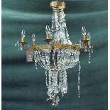 A modern gilt metal six branch chandelier of pierced circular form,