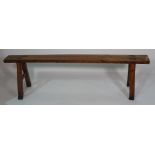 A 19th century fruitwood trestle ended bench, 161cm wide x 45cm high.