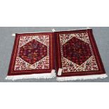Two similar Baluchistan mats, each with an indigo field and ivory surround, filled with birds,