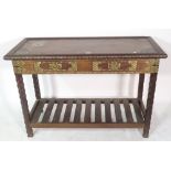 A 20th century African hardwood and brass studded two drawer side table, 117cm wide x 77cm high.