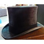 Herbert Johnson, 38 New Bond Street, London; a silk top hat in a brown leather case.