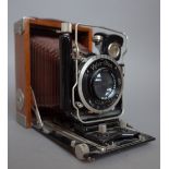 A Zeiss Ikon Tropen Adoro camera, circa 1930, with teak body and folding mechanism.