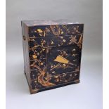 A 20th century Japanese gilt and polychrome lacquer kodansu/table cabinet with an arrangement of