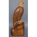 Ian Brennan, a beechwood carved sculpture depicting a bald eagle with salmon on a naturalistic base,