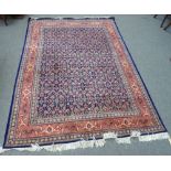 A pair of Kashan carpets, Persian, each indigo field with an all over herate design,