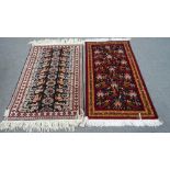 A Baluchistan rug, the black field with stylized flowerheads,