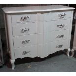A serpentine white lacquer chest of four long drawers on cabriole supports, 126cm wide x 100cm high.