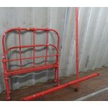 A red painted tubular metal single bed, 96cm wide.