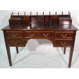 A Regency style mahogany desk on tapering supports, 122cm wide x 97cm high.