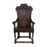 An 18th century and later oak open arm commode chair with carved back.