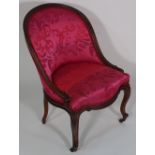 A 19th century French walnut framed pink upholstered nursing chair on cabriole supports, 77cm high.