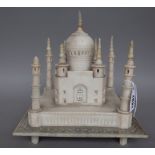 A carved alabaster model of the Taj Mahal, India, circa 1900, on a square plinth and four feet, (a.