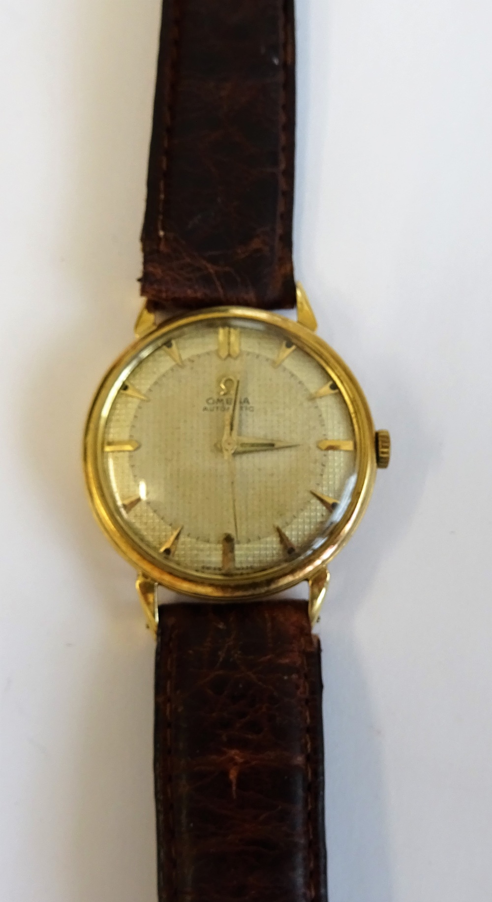 An Omega Automatic gold, circular cased gentleman's wristwatch,