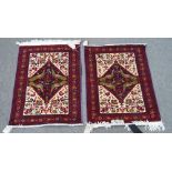 A pair of Baluchistan mats, each with an indigo field with four birds, ivory floral vase spandrels,