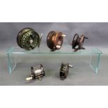 A collection of five fishing reels: one stamped Made in England, another stamped R.