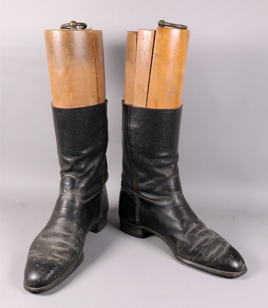 A pair of vintage black leather riding boots, with wooden trees, one labelled 'Maxwell Dover Street,