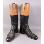 A pair of vintage black leather riding boots, with wooden trees, one labelled 'Maxwell Dover Street,