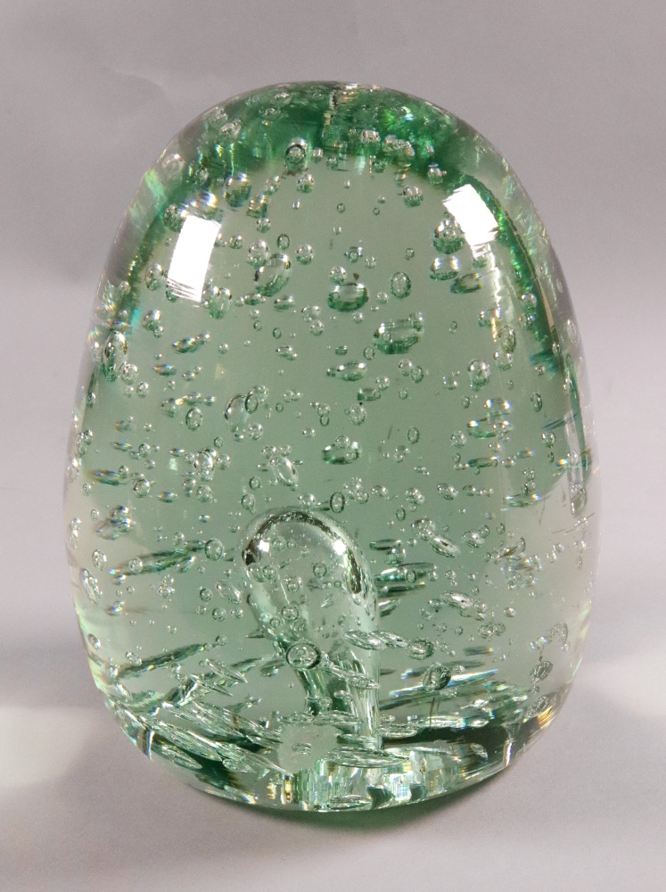 A large Victorian green glass dump, suffused with bubbles, 18cm high.