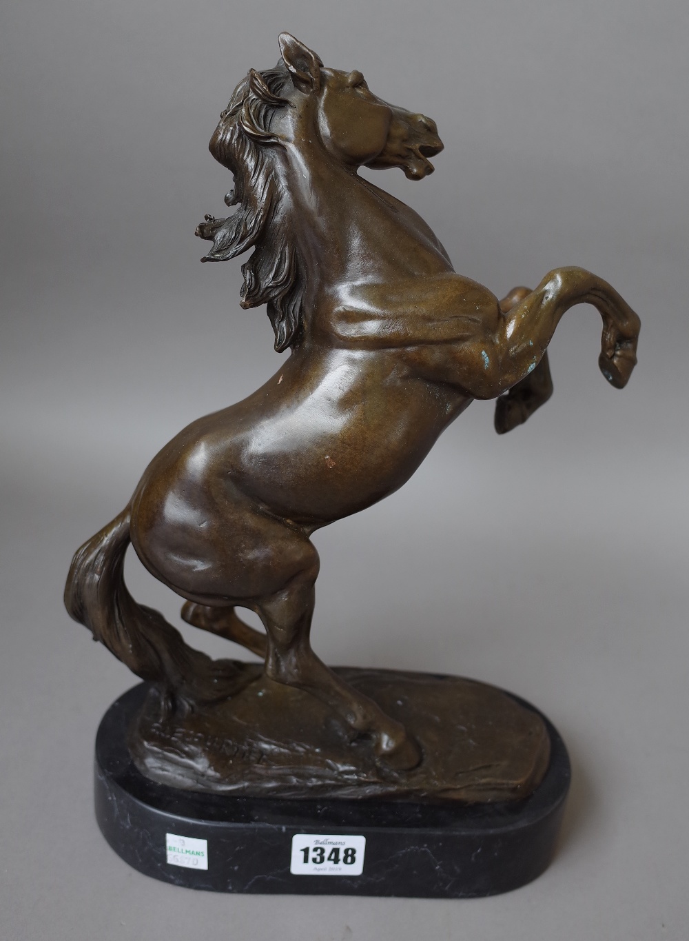 A modern bronze horse on a black marble plinth, signed 'P.