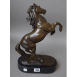 A modern bronze horse on a black marble plinth, signed 'P.