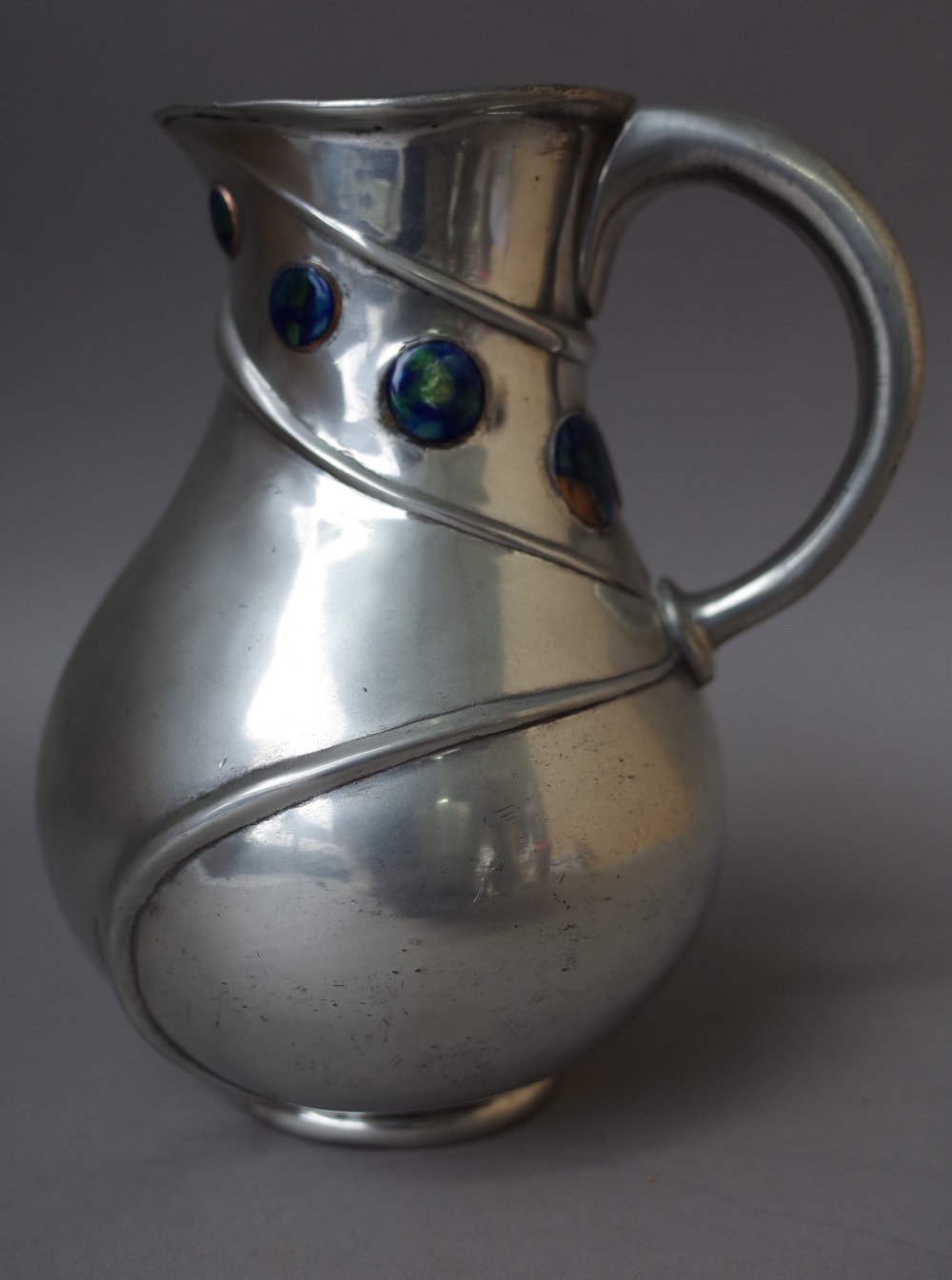 A Liberty Tudric pewter jug, after a design by Archibald Knox,