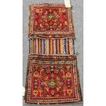 A South Persian saddlebag, the two madder bag covers each with Herati design, 100cm x 43cm.