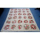 A needlework tapestry, made up of six rows of fine squares, each bearing floral bouquets,