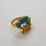 A gold and turquoise set ring, designed as a spray,