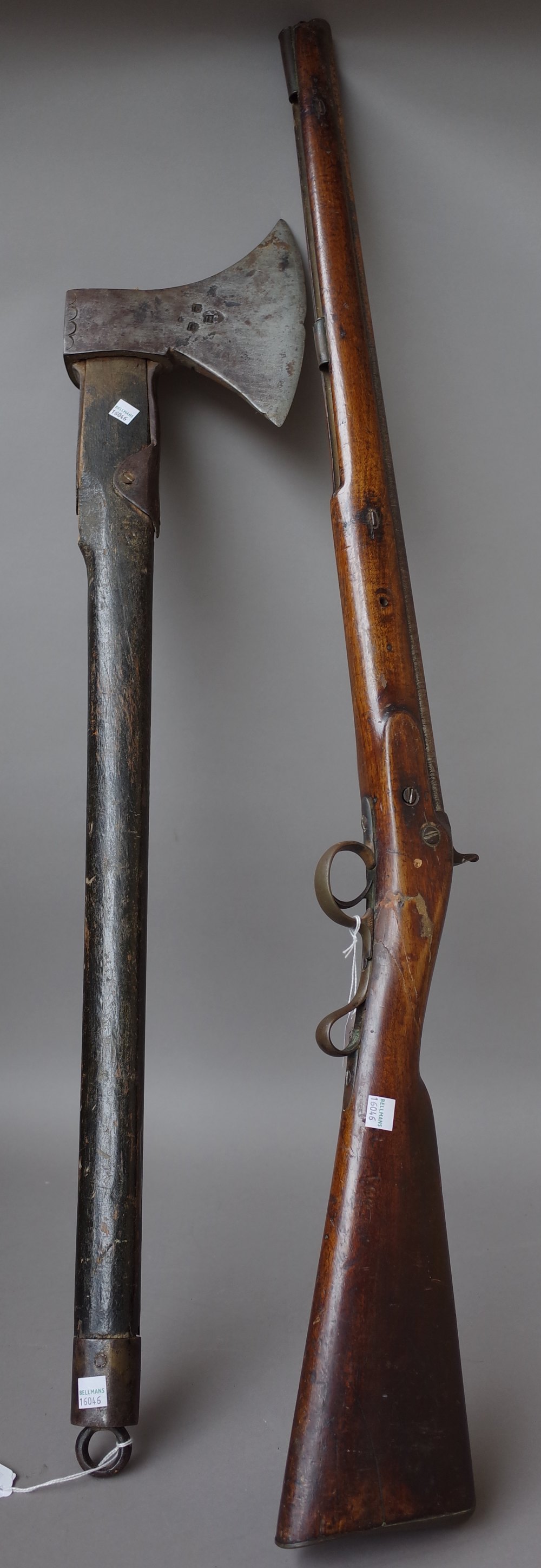 An unusual early 19th century steel axe with stamped marks to the blade with an ebonised shaft and