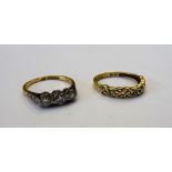 A gold and platinum, diamond set three stone ring, mounted with circular cut diamonds,