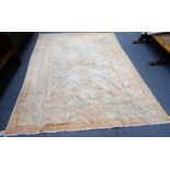 A Turkish carpet, the ivory field with a central pale medallion and matching spandrels,