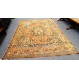 A Tabriz carpet Persian, the madder field with a dark brown and pale indigo rosette medallion,