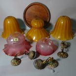 Two cranberry glass ceiling lights, three yellow glass shades,