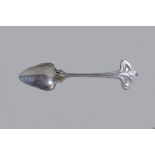 In the manner of Archibald Knox for Liberty & Co; a polished metal preserve spoon,