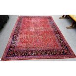 A fine Kashan carpet Persian, the madder field with an allover floral design,